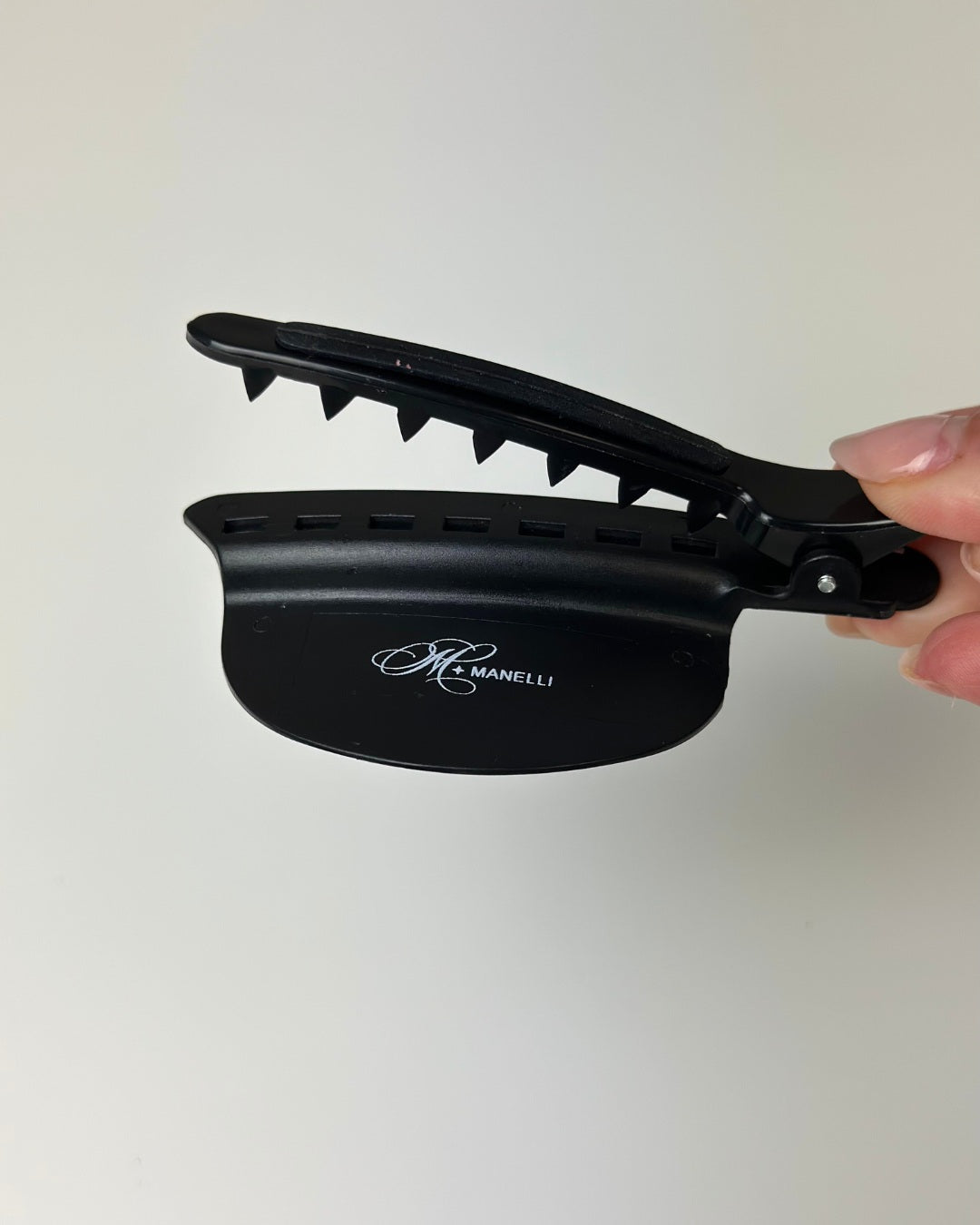 Black Keratin Hair Extensions Bond Clip by Manelli against white background